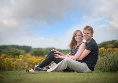 couple sitting on the grass in Formby woods